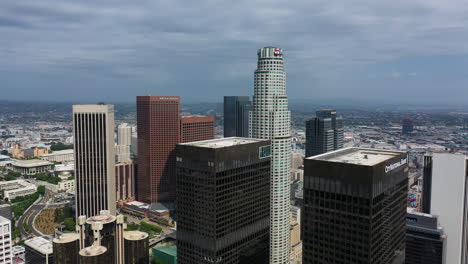 Aerial-view-flying-around-high-rise-in-sunny-downtown-Los-Angeles,-USA