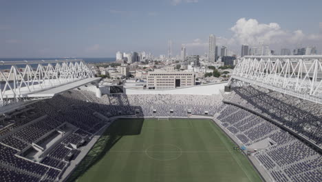 Raw-file---Bloomfield-football-Stadium-amazing-engineering-and-finest-grass,-empty-from-people-in-Jaffa-Tel-Aviv,-it-renovated-for-3-years-and-It-is-the-home-of-3-clubs,-city-skyline-at-background