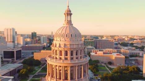 Downtown-Austin,-Texas-State-Capital-Building,-Aerial-Drone-Shot-Flying-over-Goddess-of-Liberty-Statue-on-Top-with-Views-of-The-University-of-Texas-at-Austin-Campus-Skyline-at-Sunset-in-4K