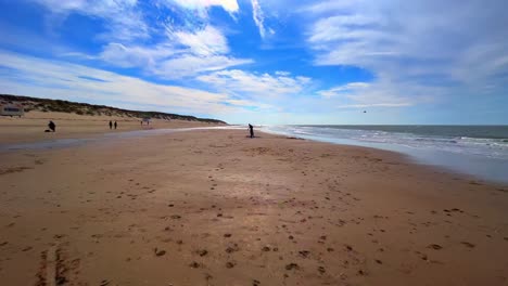 Paseo-En-Primera-Persona-Por-La-Playa-Holandesa-De-Texel-Con-Arena,-Gente,-Mar-Y-Olas.