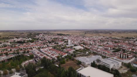 Aerial:-Alentejo's-vastness,-Castro-Verde-village-amidst-rolling-golden-fields,-Portugal
