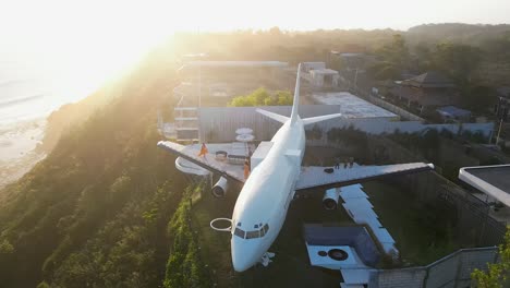 Female-tourist-walks-on-wing-of-Jet-Villa,-Bali-tourism-destination