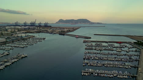 Massive-pier-and-industrial-harbor-of-Alhesirasa-town-in-Spain,-aerial-view