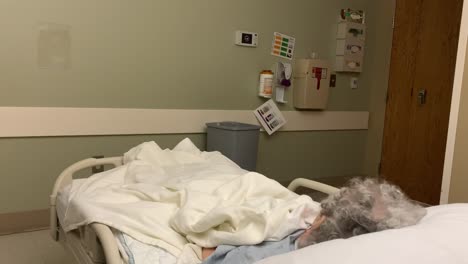Sick-Caucasian-elderly-woman-in-hospital-bed