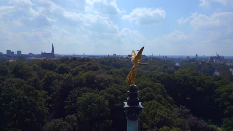 Spectacular-aerial-top-view-flight-Gold-Angel-of-Peace-column-City-town-Munich-Germany-Bavarian,-summer-sunny-cloudy-sky-day-23