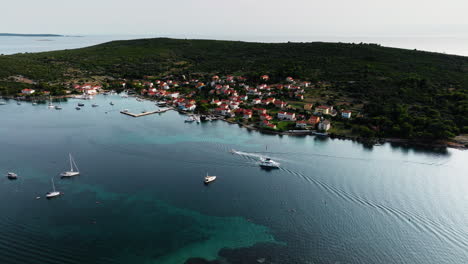 Boats-pass-by-each-other-entering-and-exiting-port-harbor-of-Ilovik-island-Croatia