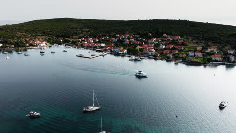 Drone-tracking-follows-speed-boat-exiting-channel-outside-of-Ilovik-island-Croatia