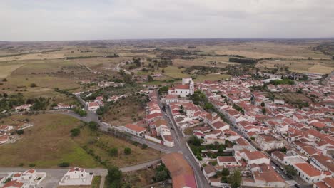 Aerial-view-of-plain-and-traditional-village-Castro-Verde-in-Portugal,-flyover