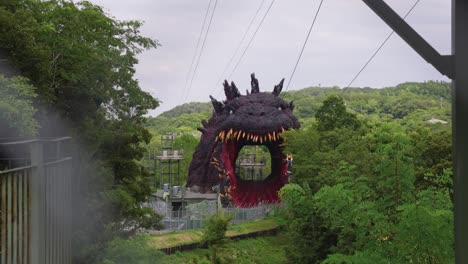 Japanese-Person-Ziplines-Towards-Giant-Godzilla-Mouth