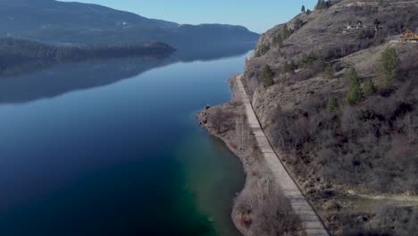 Old-Train-Track-Converted-into-Walking-Trail-called-the-Rail-Trail-|-Beautiful-Landscape-with-Glassy-Reflective-Kalamalka-Lake,-in-Vernon-British-Columbia,-Canada