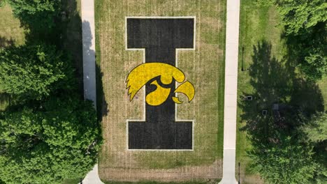 Top-down-shot-of-University-of-Iowa-Hawkeyes-logo-on-lawn-of-old-capitol-building-of-IA