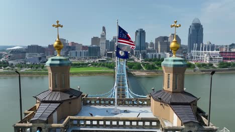 American-Bennington-Flag-waving-on-bridge-connecting-Cincinnati,-Ohio-and-Covington,-Kentucky-over-Ohio-River
