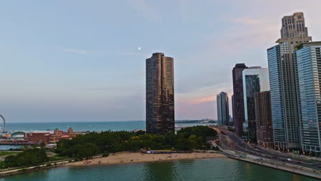 Vista-Aérea-Hacia-La-Playa-De-Ohio-Street-Y-La-Torre-Lake-Point,-Puesta-De-Sol-En-Chicago