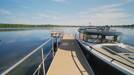 Walking-on-a-Wooden-Pier-Towards-Lake-Moored-Yacht-on-Summer-Day---Eye-Level-Gimbal-Push-In
