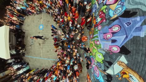 Cool-male-artist-enthuses-a-group-of-children-in-school-yard-during-music-performance