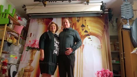 Mother-and-son-posing-in-old-fashioned-photo-studio-in-front-of-Mediterranean-background