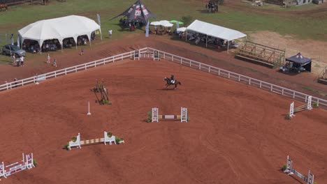 Aerial-view-of-the-horse-rider-performing-stunts-at-the-showjumping-event