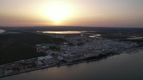Aerial-View-of-the-Coastal-village-of-Vila-Real-Santo-Antonio-at-Sunset