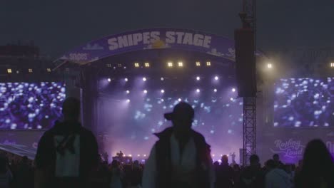Huge-stage-on-a-hiphop-festival-with-people-dancing-and-walking-around