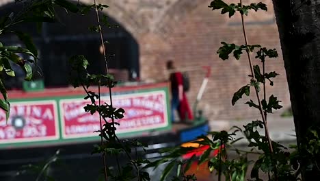 Walking-past-the-boats-on-the-Regents-Canal,-London,-United-Kingdom