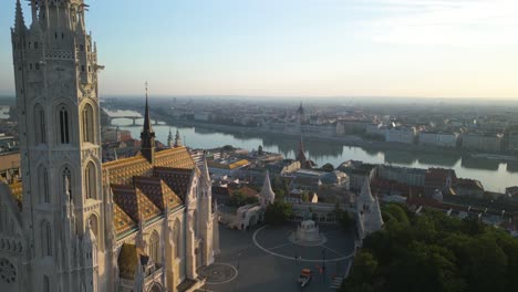 Matthias-Church-and-Fisherman's-Bastion-in-Budapest,-Hungary---Beautiful-Drone-Flight-Reveals-Cityscape