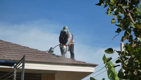 Asian-Worker-use-Blower-to-Clean-the-Dust-on-Rooftop