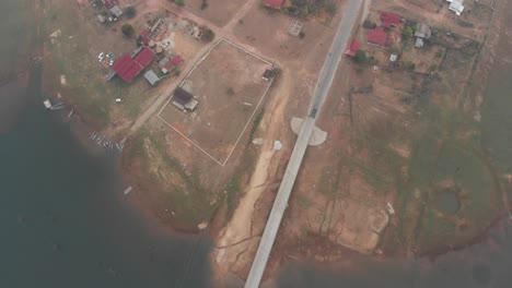 Top-down-view-of-bridge-that-crosses-the-Nam-Theun-River-at-Laos,-aerial