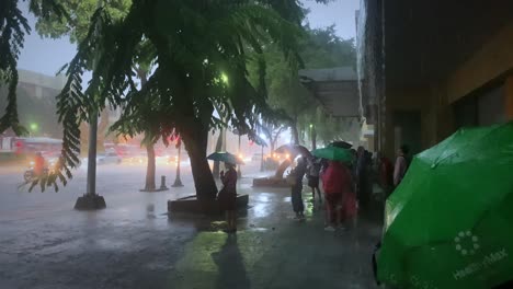 Thai-People-waiting-for-rain-to-stop-in-Bangkok-Thailand,-Monsoon-season,-4k