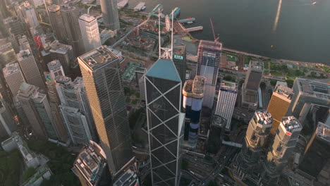 Cinematic-drone-shot-of-Bank-of-China,-Cheung-Kong-centre,-Lippo-Towers-and-Star-Ferry-pier-in-Central-financial-district-of-Hong-Kong-City