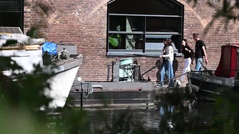 Friends-walking-along-Regents-Canal-in-September,-London,-United-Kingdom