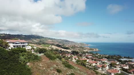 Palos-Verdes-California-Aerial-view-houses-on-hills-coast-line-overseeing-the-ocean-beautiful-homes-tech-blue-sky-water