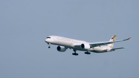 An-Etihad-Airways,-Airbus-A350-with-wheels-down-making-a-landing-at-Suvarnabhumi-Airport,-in-Bangkok,-Thailand