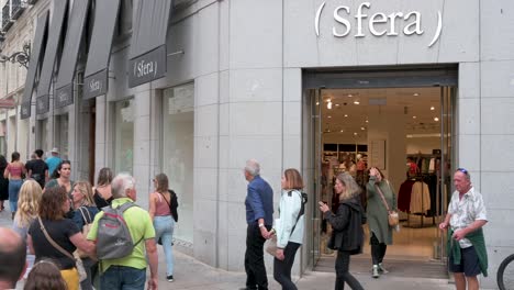 Pedestrians-and-shoppers-walk-past-the-Spanish-clothing-manufacturing-and-brand-Sfera-store