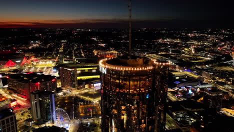 Cinematic-drone-shot-showing-top-of-Westin-Tower-in-Atlanta-with-lighting-Logo-during-golden-hour-in-the-evening