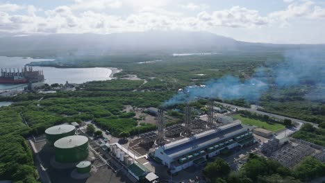 Smoking-chimneys-in-Monte-Rio-Power-plant,-Azua-in-Dominican-Republic