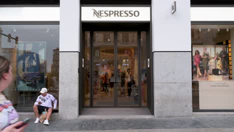 Pedestrians-and-customers-walk-past-the-Swiss-high-end-and-world-leader-in-coffee-capsules-brand-Nespresso-store