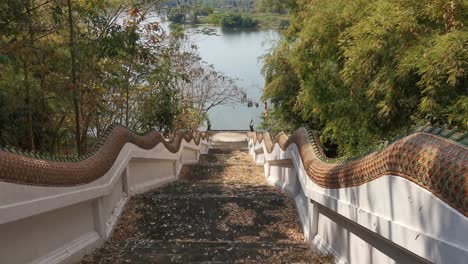 Steps-Leading-Down-to-Phu-Sai-Lake-in-Phetchaburi,-Thailand-in-front-of-Wat-Wang-Phu-Sai-Kuti-Temple