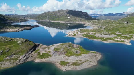 Mountain-Lake-along-Dyrskar-Tourist-Road-in-Hardangervidda,-Norway---Aerial-Circling