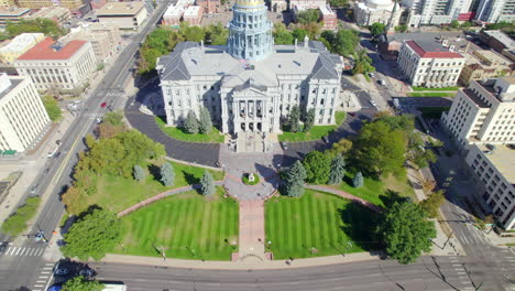 Drone-Pan-Up-Revela-El-Edificio-Del-Capitolio-Del-Gobierno-Del-Estado-De-Colorado-Y-El-Parque-Del-Centro-Cívico-En-El-Centro-De-Denver,-Colorado,-Estados-Unidos