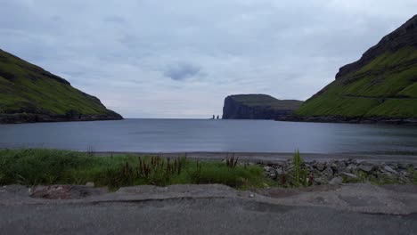Drone-landing-on-Tjronuvik-with-Risin-og-Kellingin-in-background,-Faroe-Islands