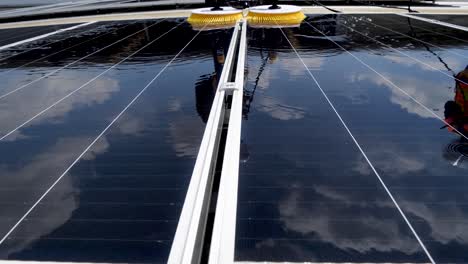 Worker-Use-Machine-to-wash-Solar-Cell-Panel,-Daylight