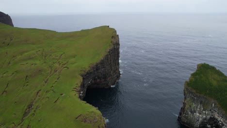 Faroe-Islands-aerial-of-Vagar-Island-and-Drangarnir-green-turfed-top-sea-stacks