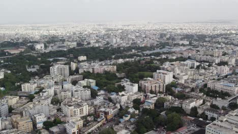 Aerial-footage-shows-crowded-mid-size-apartments-and-Railway-Station-Train-leaving-in-a-city-in-India,-the-commercial-area-around-Star-hotels,-and-one-of-the-city's-wealthiest-neighbourhoods
