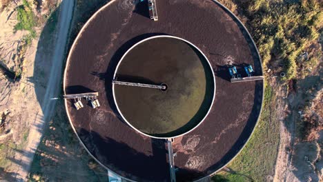 Water-Filtration-and-Purification-Station,-Birdseye-Aerial-View-of-Circular-Pool-on-Sunny-Day