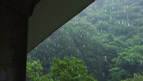 Tropical-Rain-over-Mountains,-Drops-From-Rooftop