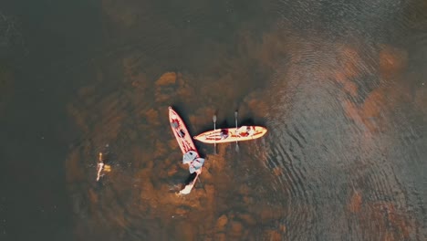 Aerial-top-down-shot:-group-of-people-in-kayak-having-fun-in-Tropical-Amazon-river-during-sunny-day-in-Brazil---rising-shot