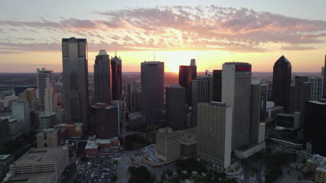 Aerial-view-toward-the-East-skyline-of-Dallas,-dramatic-sunset-in-Texas,-USA