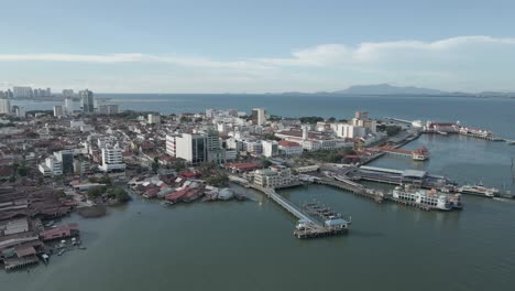 Aerial-pans-across-ferry-terminals-at-George-Town,-Penang,-Malaysia