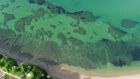 Gerakini-Beach's-allure-in-Yerakini,-Halkidiki,-Greece,-showcased-in-4K-splendor-from-a-daytime-drone-perspective