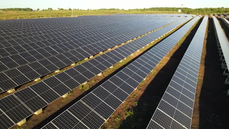 Aerial-view-across-rows-of-green-solar-panel-field-generators-producing-clean-alternative-electrical-energy